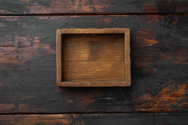 istock Rustic wooden box or container with copy space for text or food, top view flat lay , on old dark  wooden table background 1352418616