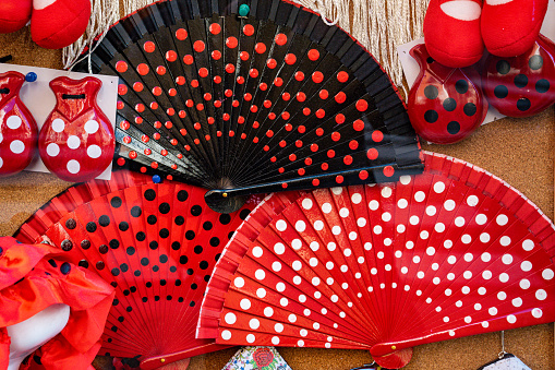 Madrid (SPAIN) November 05, 2021: Fans and castanets, typical Spanish souvenirs with red, white and black flamingo polka dots.