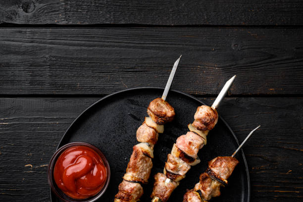 istock Grilled kebab, on black wooden table background, top view flat lay, with copy space for text 1352420026