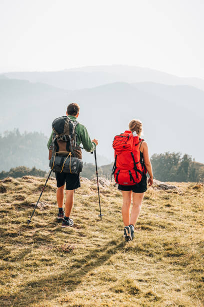 istock Friends hike towards viewpoint on mountain ridge 1352420254