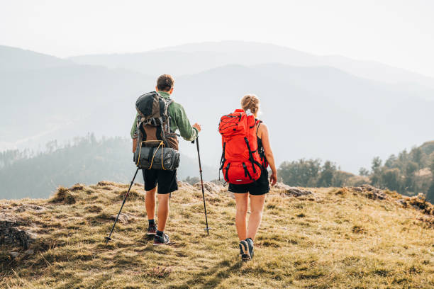istock Friends hike towards viewpoint on mountain ridge 1352420257