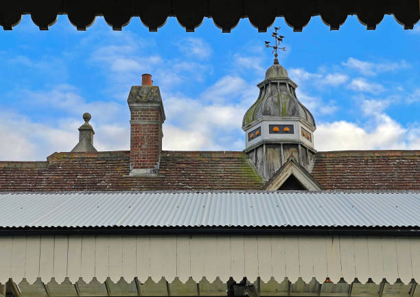 weathercock with a bell on a small wooden tower