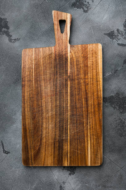 istock Bamboo kitchen cutting board empty for empty for copy space for text or food, top view flat lay , on gray stone table background 1352420665