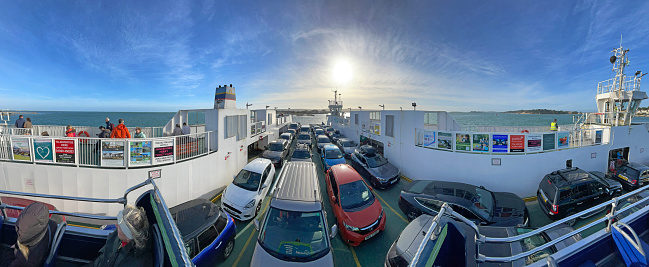 Car ferry crossing Poole Harbour entrance at Shell Bay near Studland, Dorset, England, UK. A recreational hub on the south coast of England, Poole harbour, the second largest natural harbour in the world, attracts tourists, yachtsmen, hikers and horseriders alike in pursuit of leisure activities along the coastline and water's edge.