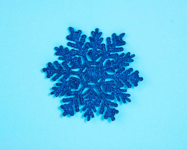 istock Blue toy snowflake glitter shiny on blue background with copyspace postcard 1352421483