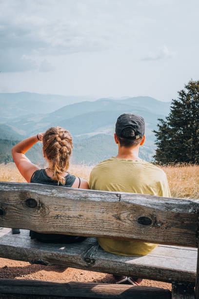istock Hiking friends relax on grassy mountain ridge 1352422814