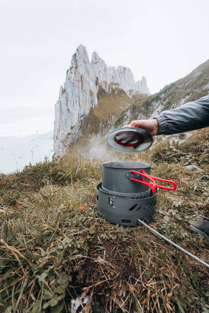 istock View of water boiling in camping stove, on grass slope 1352422980