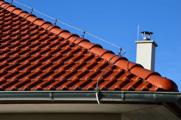 Photo of earth conductor must be installed on each red roof, which copies the outline of the building and protects the truss from lightning, including the gutter and the metal roof