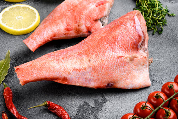 Fresh red perch or sea bass, on gray stone table background Fresh red perch or sea bass set, on gray stone table background fillet red snapper fish raw stock pictures, royalty-free photos & images