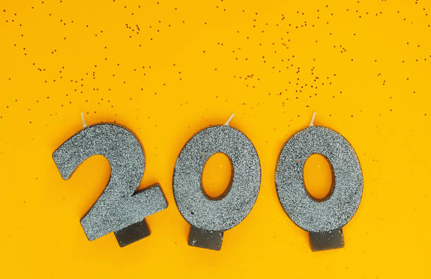 istock Symbols 200, silver candles on yellow background with glitters. 1352424466