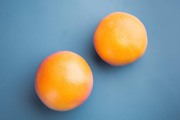 istock Grapefruit whole, on blue textured summer background, top view flat lay, with copy space for text 1352424701