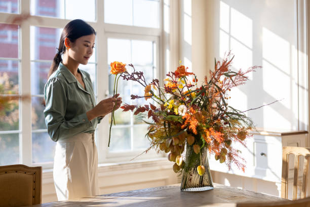 istock A woman who arranges flowers at home 1352425681