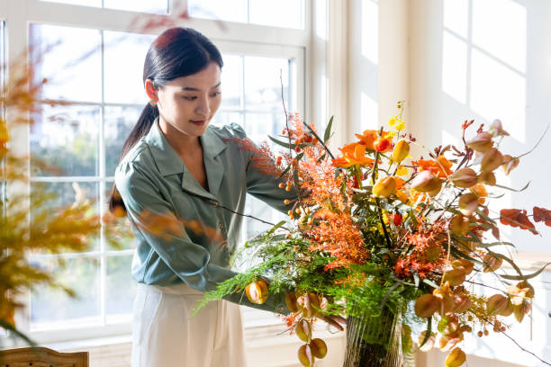 istock A woman who arranges flowers at home 1352425819