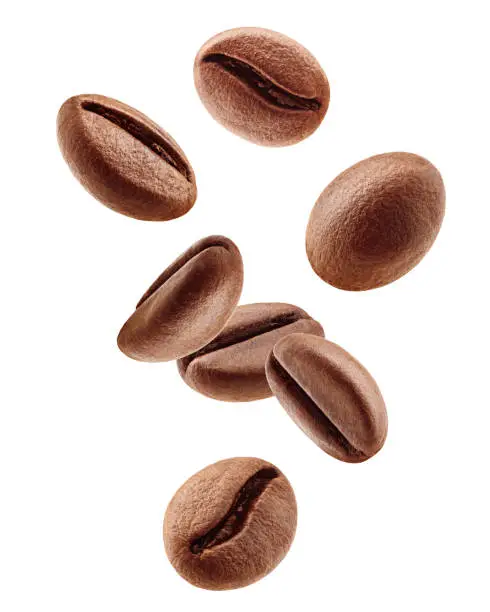 Photo of Falling coffee beans isolated on white background, clipping path, full depth of field