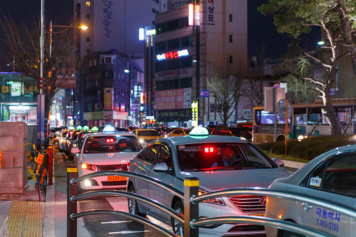 Busan, South Korea - March 24, 2016: Night city street with standing taxi.