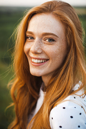 Beautiful red haired woman with freckles. Pretty young woman. Luxury travel. Beauty face.
