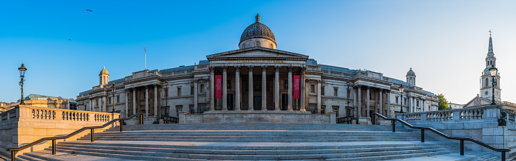 London, UK - May 21, 2019: The Royal Exchange with the modern buildings of the City of London in the background. The Exchange was opened in 1571, and currently it serves as a luxury shopping centre.