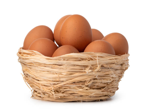 istock Eggs in basket isolated on white background 1352428958