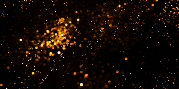 istock Golden abstract bokeh on black background. 1352430731