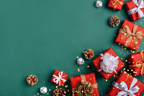 istock Gift boxes with white and brown bows on a green backdrop. 1352430746