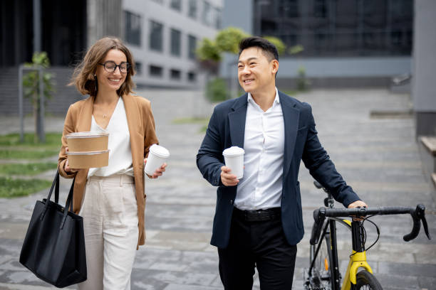 istock Business people walk, drink coffee and talk 1352432249