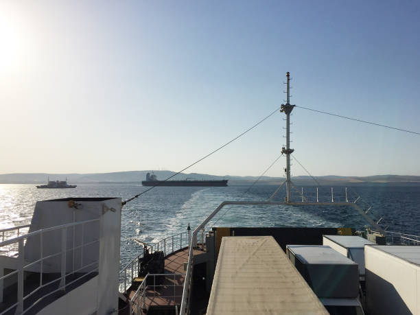 istock Ferry with land vehicles on the sea 1352433565