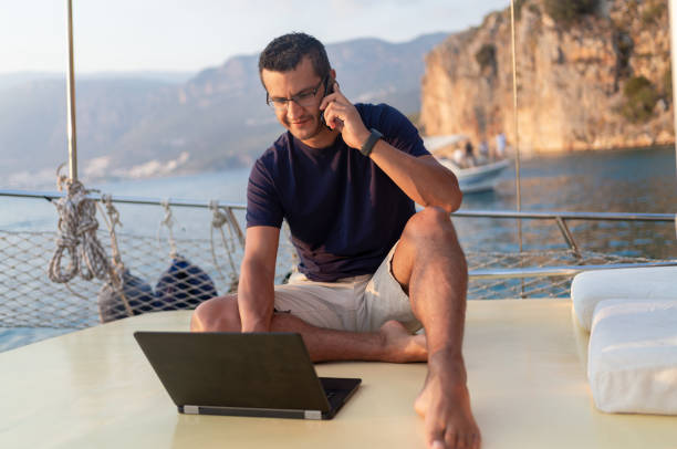 istock Man On A Luxury Yacht Working During Vacation 1352433585