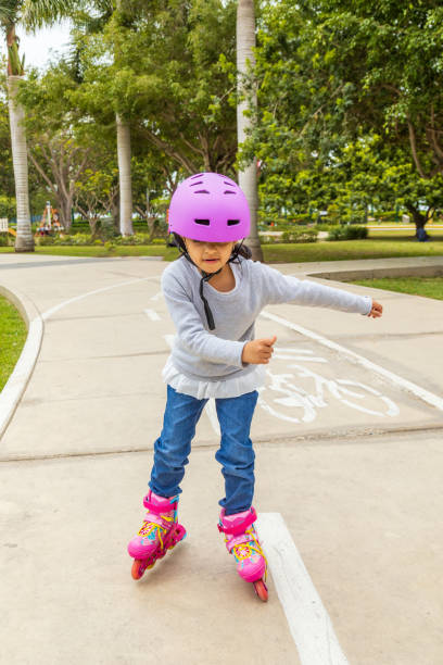 istock Little girl is skating with her roller skates 1352433586