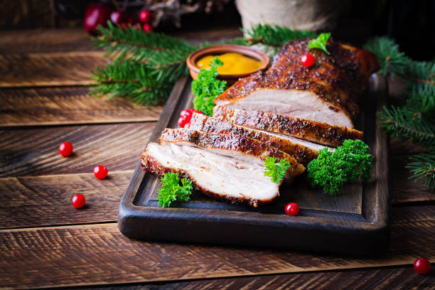istock Baked pork belly with herbs. Boiled pork. Festive Christmas table. 1352433780