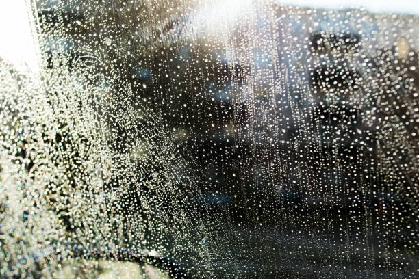 istock Raindrops on glass in light of sun 1352433848