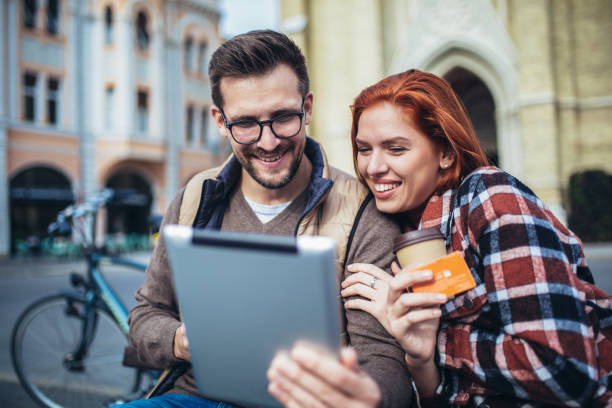 istock Young couple using tablet and credit card. 1352434837
