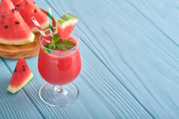 watermelon cocktail with mint and ice. summer refreshing drinks in glasses on blue wooden table. concept of healthy summer eating. - healthy eating food and drink nutrition label food imagens e fotografias de stock