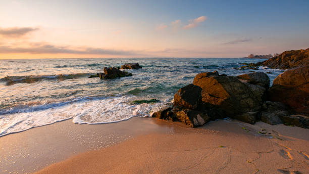 istock huge stones on the sandy beach at sunrise 1352435294