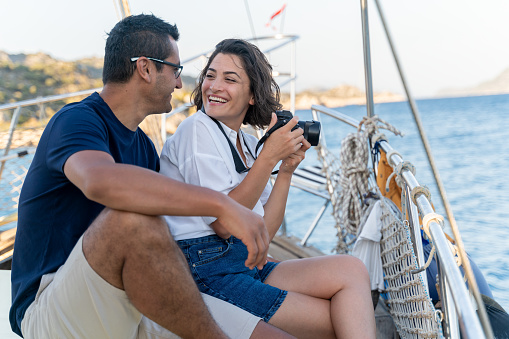 Young Couple Enjoying Summer Vacations On A Yacht , Take Photo And Having Fun Traveling