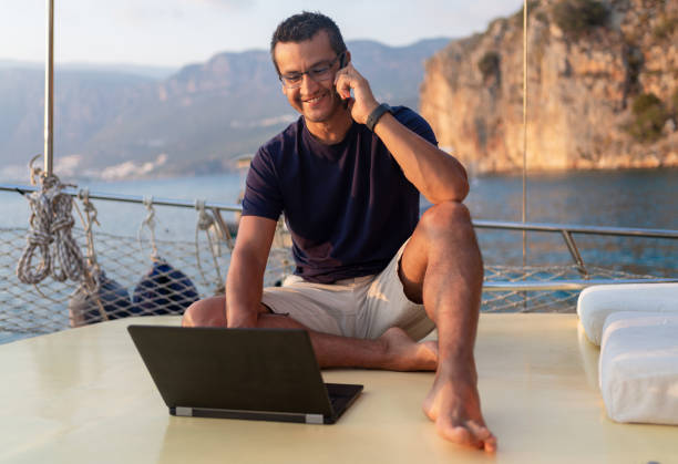 istock Man On A Luxury Yacht Working During Vacation 1352435494