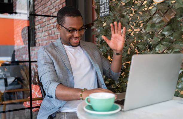 istock Man On A Video Conference Call At Coffee Shop 1352438697