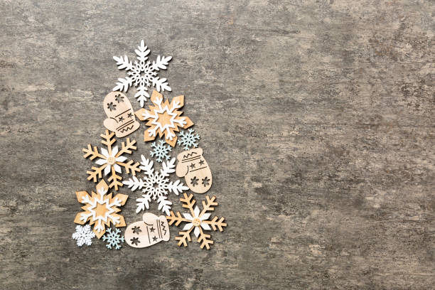 istock Christmas tree made from colored snowflakes decoration on colored background, view from above. New Year minimal concept with copy space 1352439637
