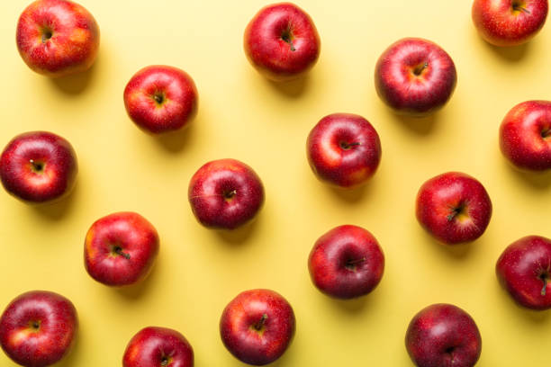 istock Many red apples on colored background, top view. Autumn pattern with fresh apple above view 1352439706