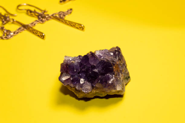 istock On a yellow background lies a semi-precious stone amethyst 1352444030