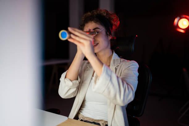 istock Woman taking a break during late work in home office and using hand telescope 1352452489
