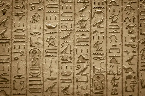 Hieroglyphics of ancient Egypt carved on sandstone wall