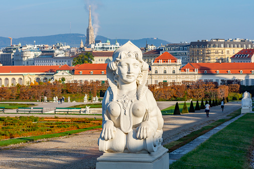 Statue in Belvedere gardens with St. Stephen's cathedral at background, Vienna, Austria