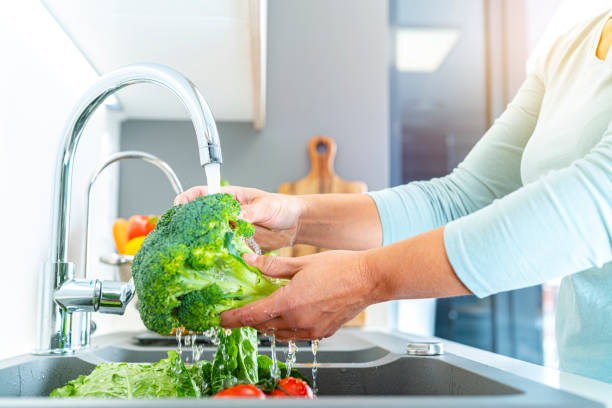 istock Washing vegetables in a sink 1352455863