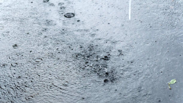 istock Rain over a puddle ripples on the surface of the water when raindrops fall. Selective focus 1352456127