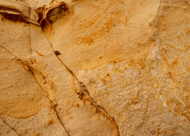 istock Yellow orange warm sandstone abstract background texture. 1352456129