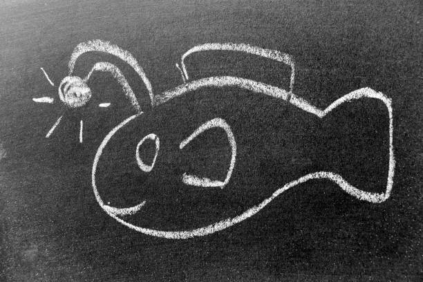 istock White color chalk hand drawing in angler fish or lantern fish shape on black board background 1352457110