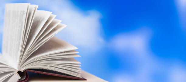 istock Open book on the background of the sky. Training pages. 1352457680