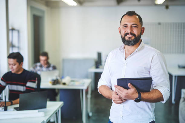 istock Shot of a businessman using his digital tablet in his office 1352458092