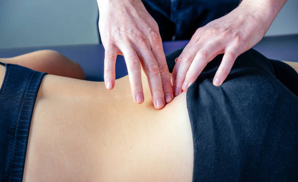 istock Physical therapist fixing sacroiliac joint pain with his hands 1352458095