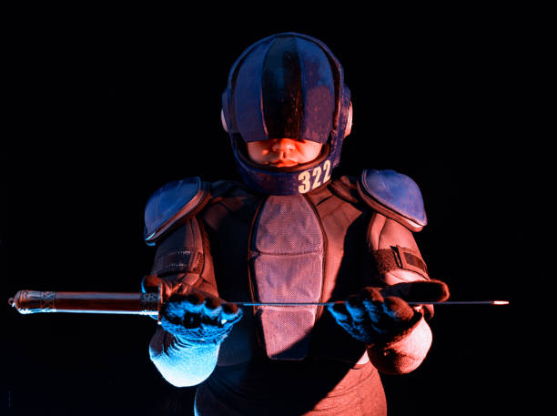 istock Cyberpunk future concept. Bionic cyborg police officer with short samurai sword stands in dark. Halfman robot looks at camera. Futuristic science fiction scene. 1352460881